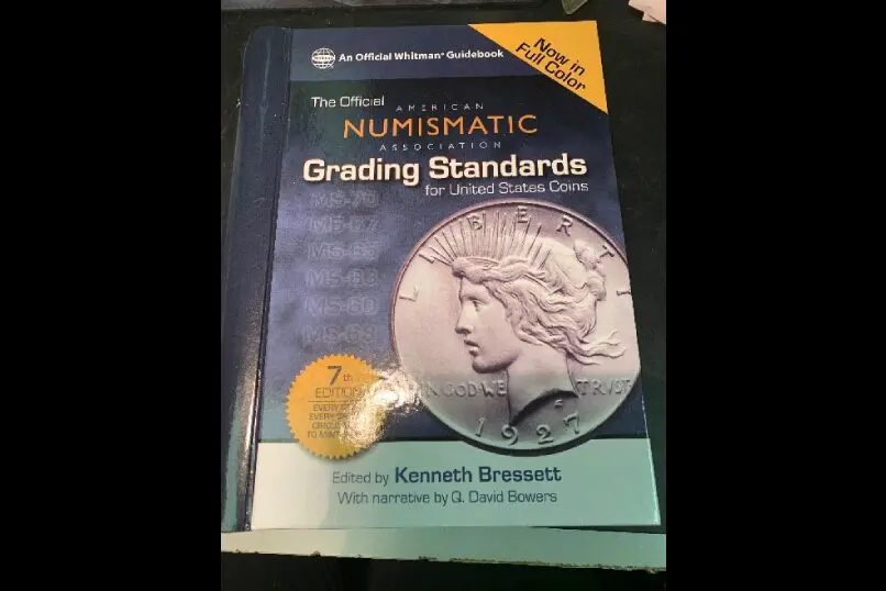 Coin grading book with silver dollar cover.