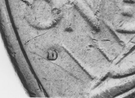 Close-up of a coin with letter "D".