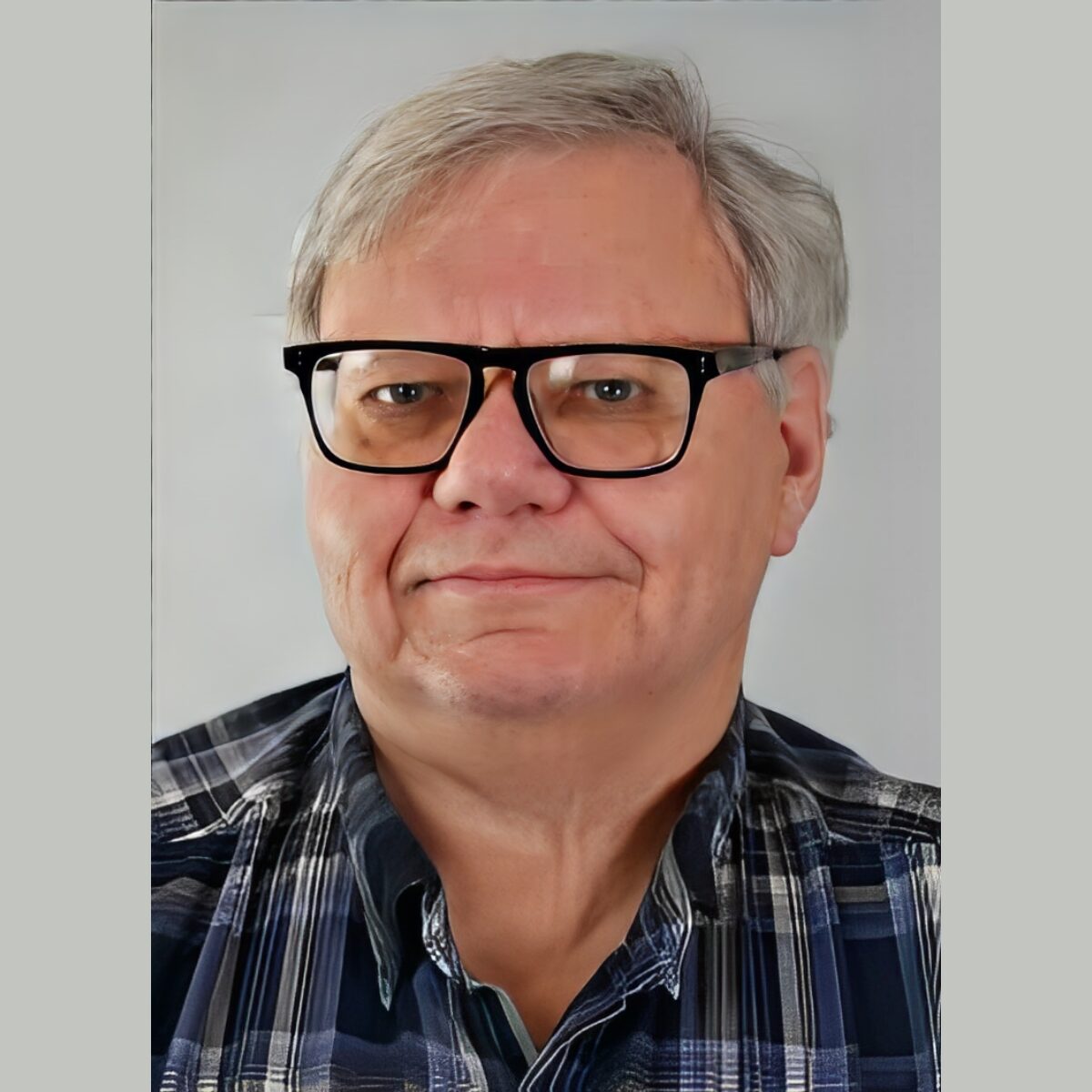 Man wearing glasses and plaid shirt.