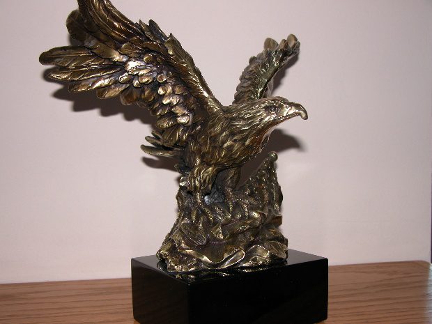 Bronze eagle sculpture on black base.
