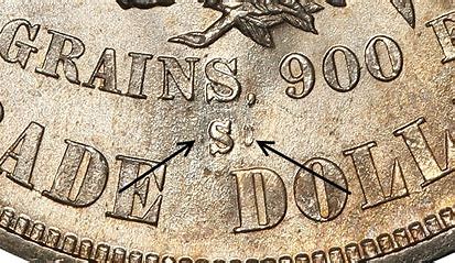 Close-up of coin with arrows pointing.