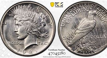 A close-up image of a silver coin showing detailed engravings and serial number.