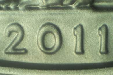 Close-up of numbers '201' embossed on a metallic surface.