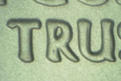 Close-up of embossed letters forming the word 'TRU'.